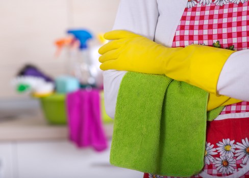Cleaner applying safety procedures during a deep cleaning task